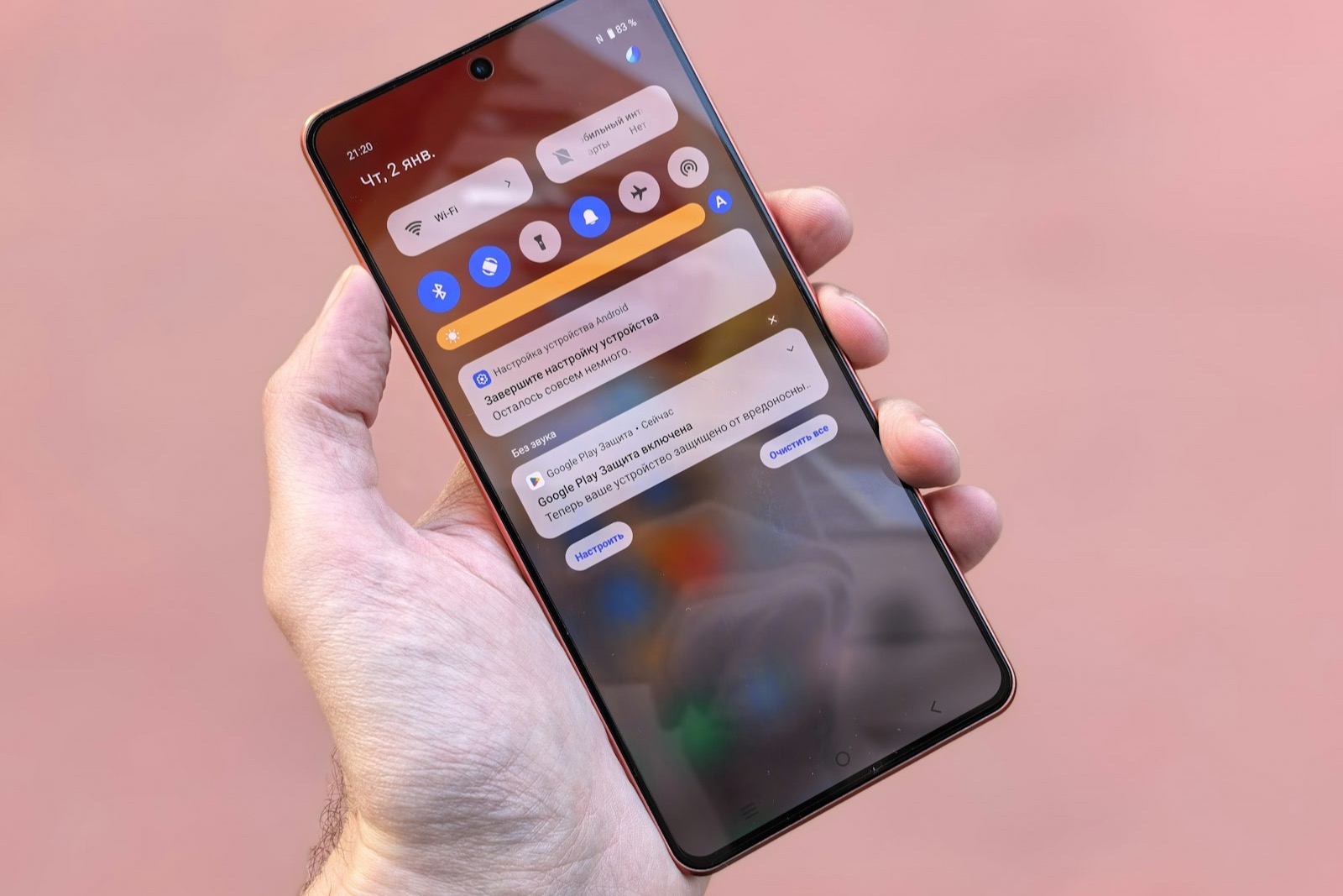 Hands holding a smartphone showing an AI platform logo, representing AI-generated email summaries replacing preheader text