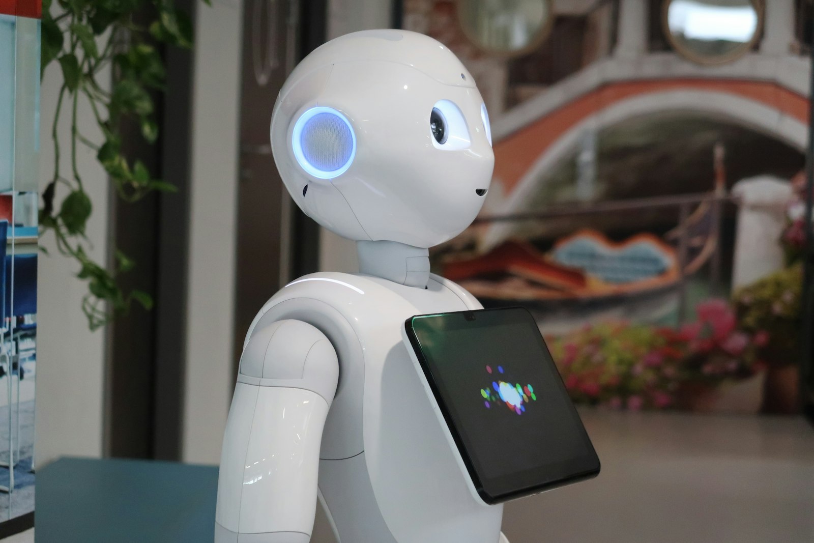 A white robot holding a tablet, representing AI-generated email and inbox detection