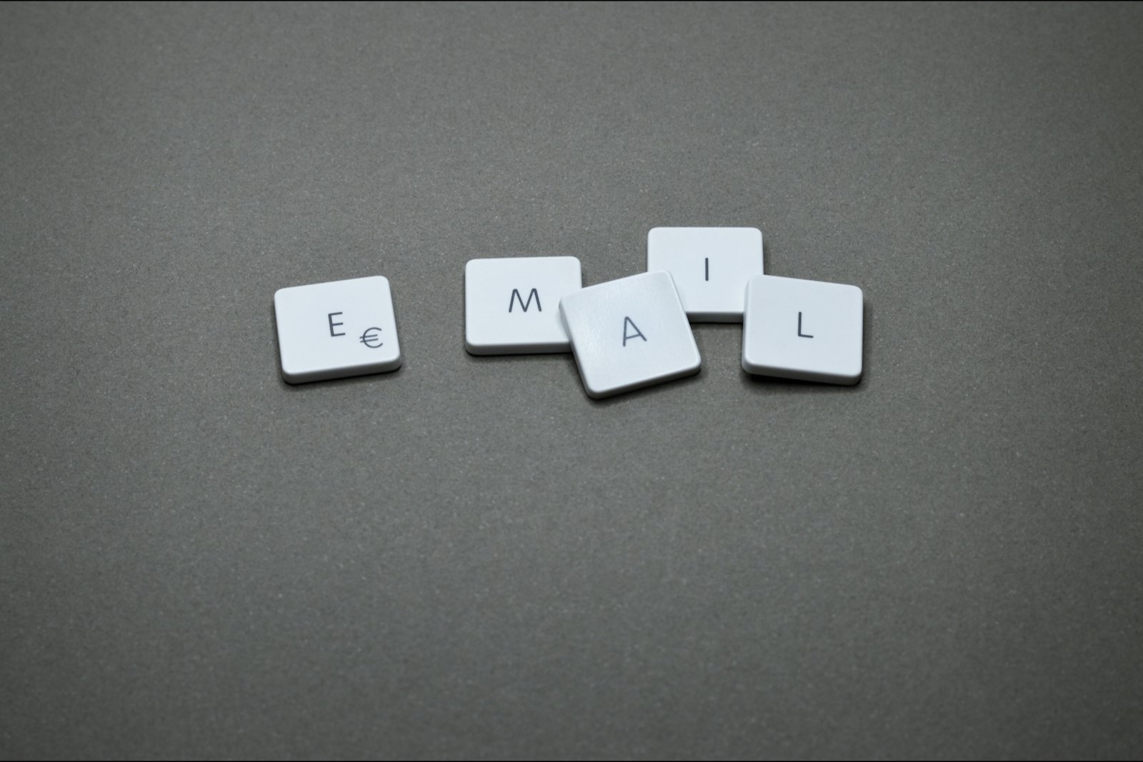 White letter tiles spelling the word EMAIL on a grey background, representing CAN-SPAM email enforcement