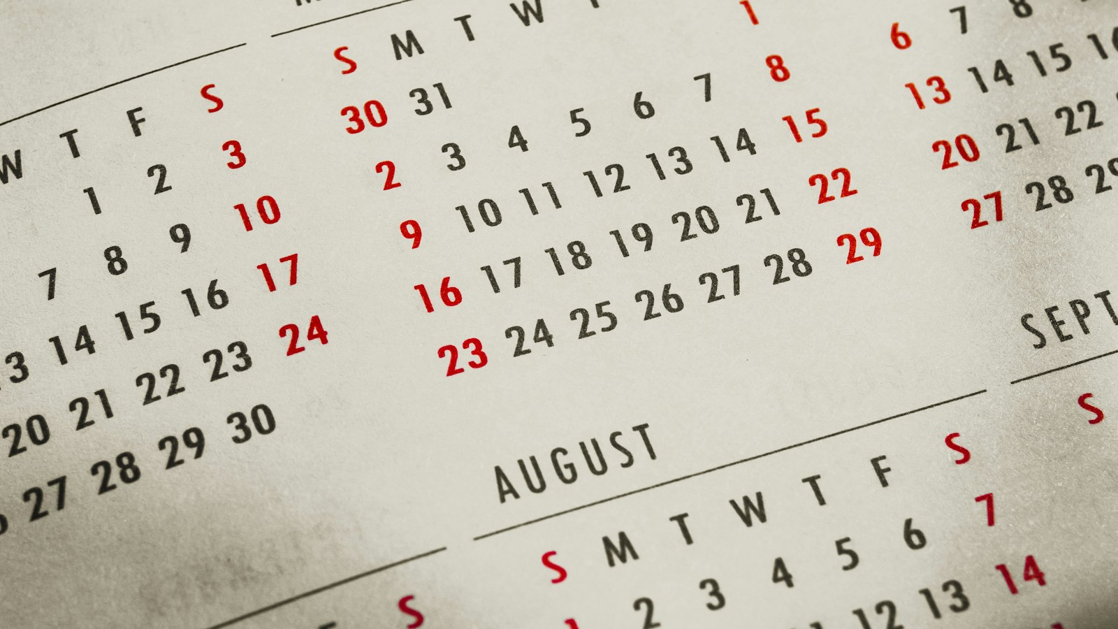 A close-up of a calendar on a table, representing a year-end review
